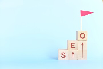 Business SEO or search engine optimization ladder to success concept. Human hand climbing wooden...
