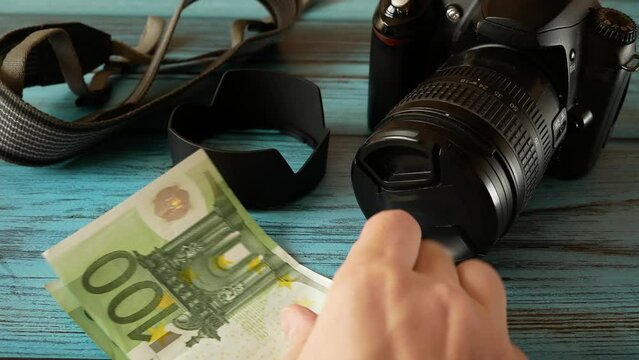 digital camera and money, store selling photographic equipment, pawnshop concept