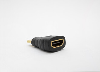 Close up of a mini HDMI adapter against a white background.