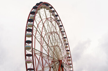 Attraction ferris wheel on the background of a stormy sky.