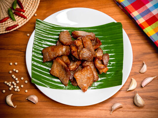 Fried pork with garlic and pepper on plate, Thai food