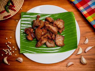 Fried pork with garlic and pepper on plate, Thai food	
