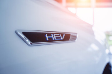 The inscription HEV on the nameplate of the modern car