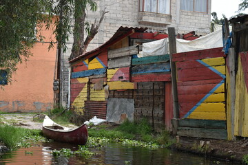 Fototapeta na wymiar Painted Shack and Docked Canoe in Xochimilco, Mexico City