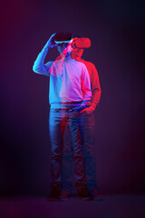 Man is using virtual reality headset. Image with double color exposure effect.