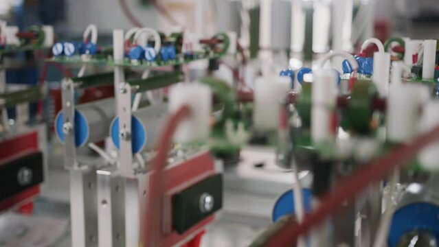 Electronic components and capacitors inside an electronic device. Close up tracking shot.