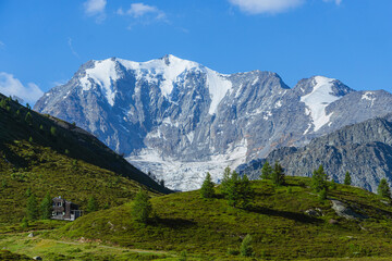 Obraz premium The landscape of the Swiss Alps, with the highest peaks and glaciers of the canton of Valais viewed from the Simplon Pass, Switzerland - July 2022.