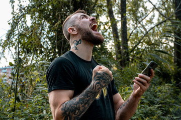 Man celebrating with the phone in his hand