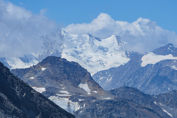 Obraz premium The landscape of the Swiss Alps, with the highest peaks and glaciers of the canton of Valais viewed from the Simplon Pass, Switzerland - July 2022.