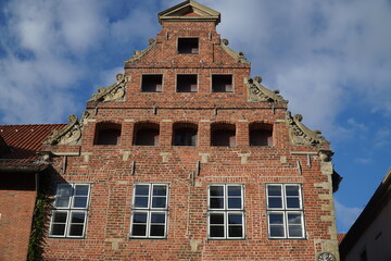Pattern of red brick wall structure as background, gables of old house facades lined up in the old town of Lüneburg, Lower Saxony, Germany.