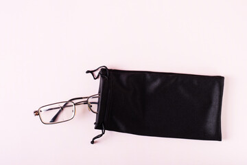 Glasses with a broken lens in a soft case. Incorrect storage of optics. Top view.