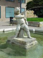 TARRAGONA, SPAIN - 06.07.2022: Fountain "Boy with the Goose" by Greek sculptor of Chalcedon at end of Rambla Nova Boulevard along embankment