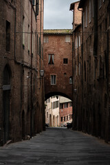 narrow street in Siena, Tuscany