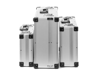 Set of metal suitcases of different sizes isolated on white background.