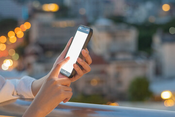 Hand pressing the phone, white screen, light of pokemon city below.