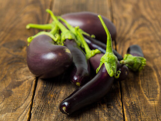 Fresh eggplant on a wooden background close-up