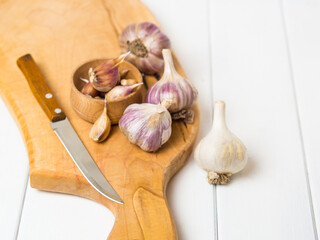 garlic. garlic clove, flask of garlic in a wooden bowl on a wooden background.Healthy food concept.