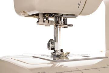 Part of electric sewing machine, macro, isolated on white background.