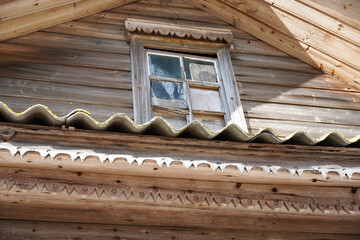 Fragment decor old rural wooden building in russian village. Broken window. High quality photo