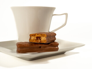 Chocolate bar and a cup of coffee on a white background.