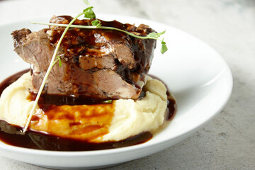 Pork on red sauce and mashed potato