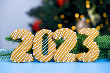 2023 Cookie number made of gingerbread cookie with white icing with Christmas tree and Christmas...
