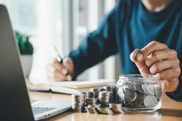 Man hands putting coins stack, Concept business finance saving money and investment.