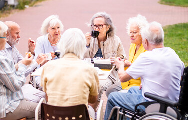 Group of seniors people bonding at the bar cafeteria - Old elderly friends meeting in a coffeehouse...