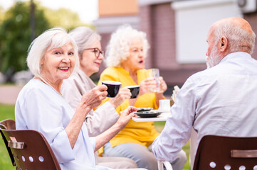 Group of seniors people bonding at the bar cafeteria - Old elderly friends meeting in a coffeehouse...