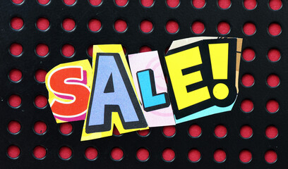 SALE words written on a piece of paper. Time for promotions and sales in stores.