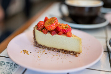 dessert cheesecake on a plate with strawberry in a restaurant