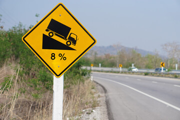 Yellow traffic sign  to warn  truck driver to drive carefully down to hill on slope a steep 8...
