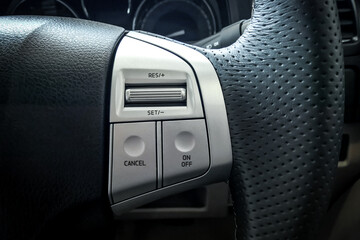 Obraz premium Cruise control button on car steering wheel