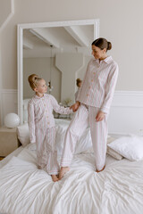 Mom and daughter in pajamas in the bedroom