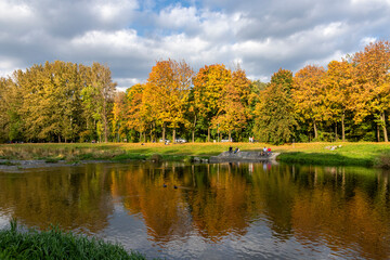 Fototapeta na wymiar Autumn riverbank in saturated colors on a sunny day