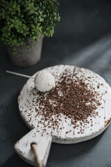 Dark chocolate pieces crushed and cocoa beans, culinary background, top view. chocolate pralines. Cake pops.