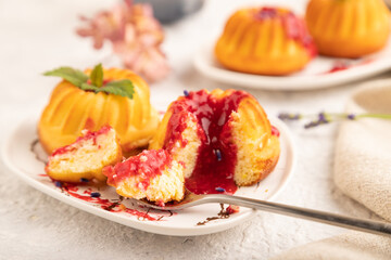 Semolina cheesecake with strawberry jam on gray concrete, side view, selective focus.