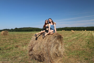Naklejka na ściany i meble group of friends in a field with a haystack