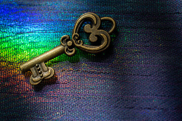 Vintage key. .Antique key. Retro key on  on colorful fabric