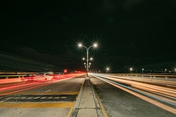 Fototapeta na wymiar Headlights traces on the road bend in the night