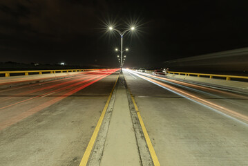Fototapeta na wymiar Headlights traces on the road bend in the night