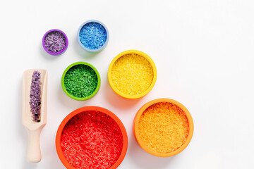 Bowls in rainbow colors with colored rice and scoops. Sensory bin toddler. Montessori material. Learning colors. Scooping and pouring activity for kids. Games for learning and development of  child