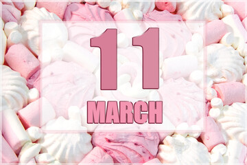 calendar date on the background of white and pink marshmallows. March 11 is the eleventh  day of the month