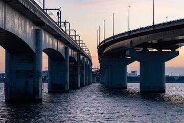 夕焼けに染まる海上の橋