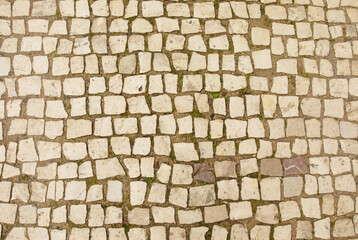 Granite cobblestoned pavement background. Full frame of regular square cobbles in rows. Natural stone textured background. 