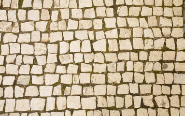 Granite cobblestoned pavement background. Full frame of regular square cobbles in rows. Natural stone textured background. 