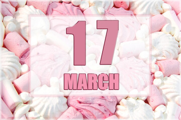 calendar date on the background of white and pink marshmallows.  March 17 is the seventeenth day of the month