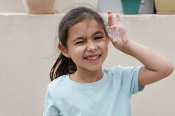 Funny child hold and shows grown crystal. Growing crystals is a popular kids craft and fun science experiment.
