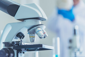 Science microscope equipment in biology chemical laboratory. Scientific experiment Microscope on Lab table microbiology equipment. Chemistry objects on lab background. Chemistry scientific concept