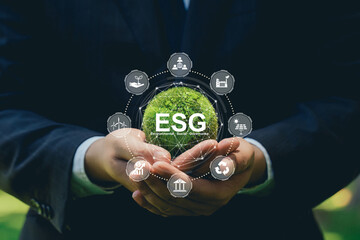 ESG environmental social governance business strategy investing concept.Businessman Embracing Green Globe with ESG icon.Green Energy Renewable and Sustainable Resources. Environmental and Ecology Care